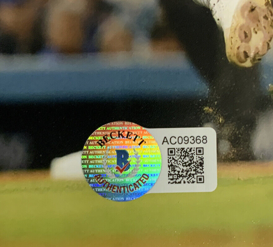 BRUSDAR GRATEROL DODGERS SIGNED 8X10 JUMPING THROW PHOTO SILVER BECKETT